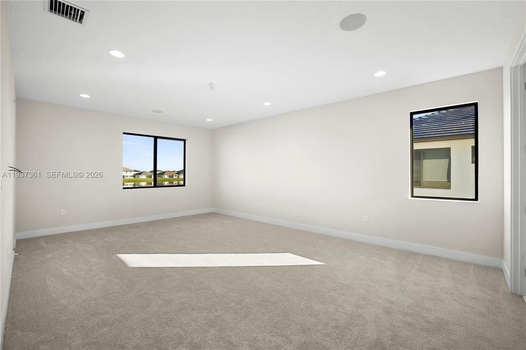 Primary bedroom with generous layout and natural light