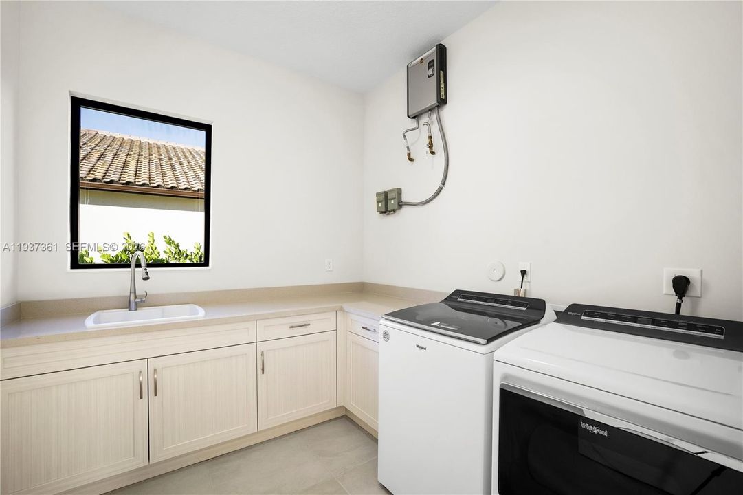 Laundry room with cabinetry and utility space