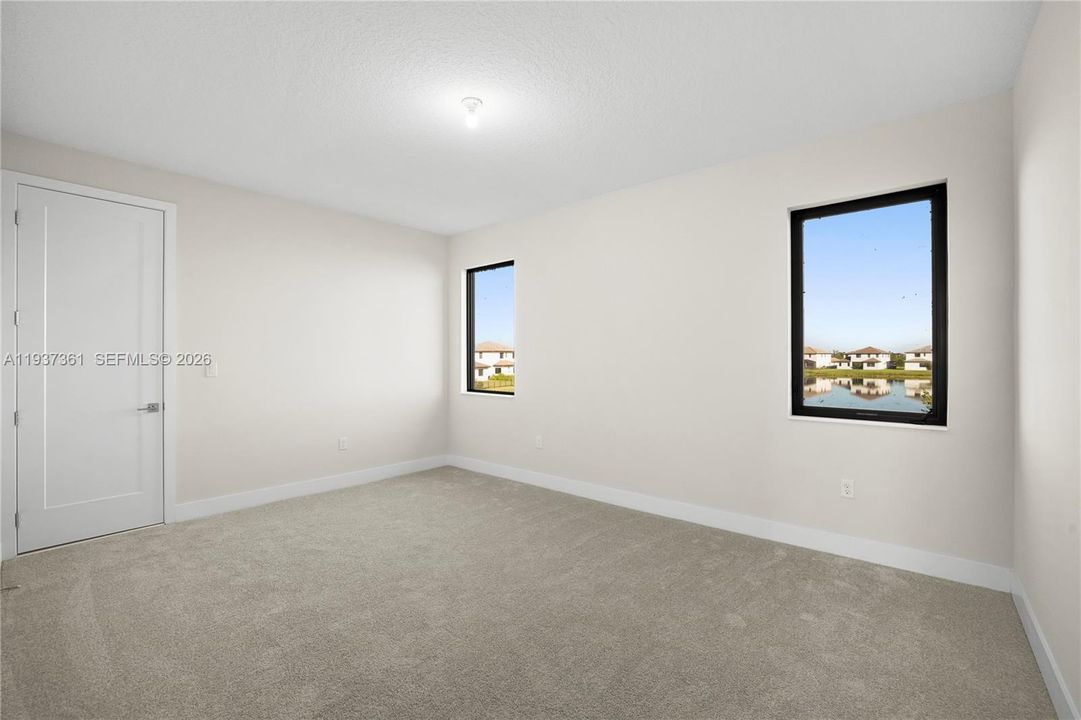 Second Jack-and-Jill bedroom with natural light and recessed lighting