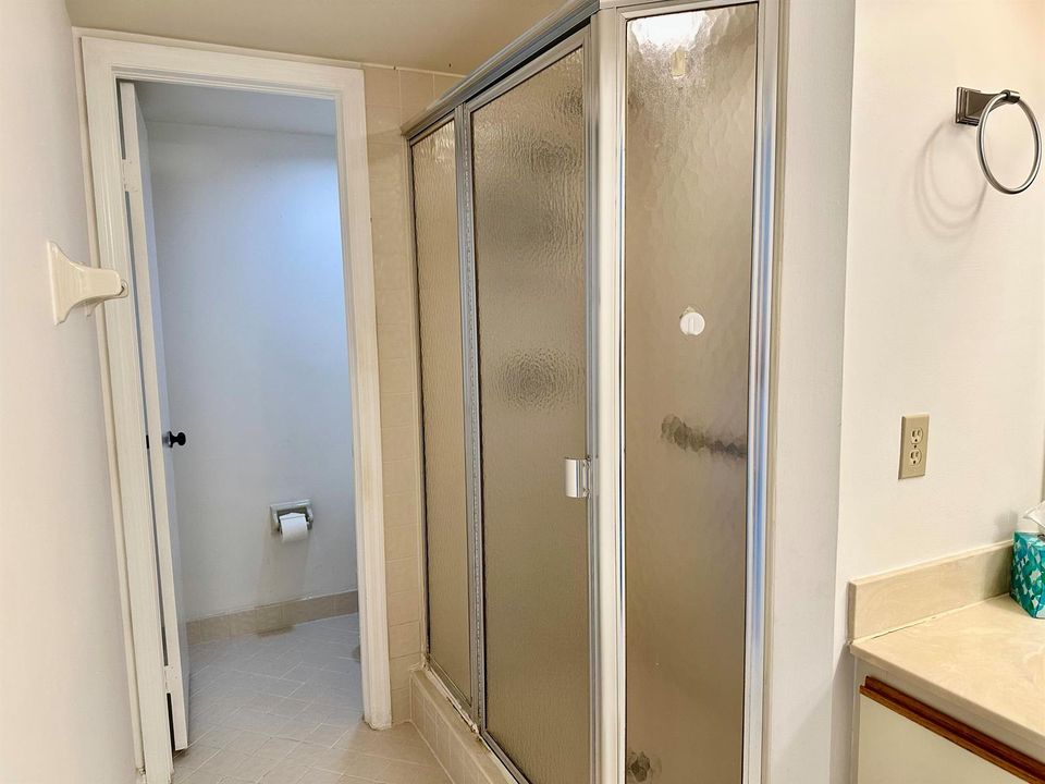 PRIMARY BATHROOM SHOWER AND PRIVATE TOIL