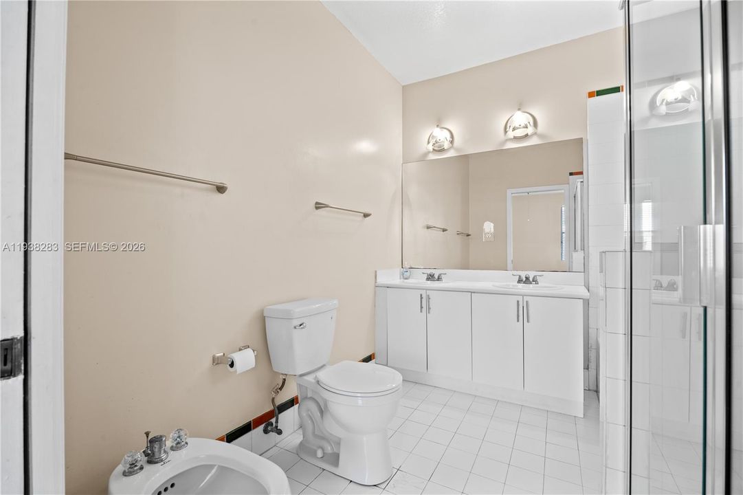 Master bathroom with bidet and dual sinks.