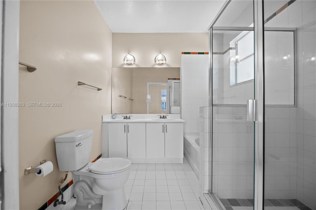 Master bathroom has standing shower and bathtub.