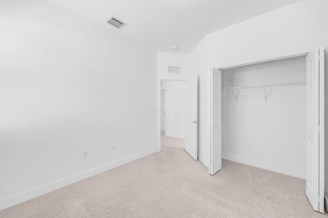 bedroom featuring carpet and a closet