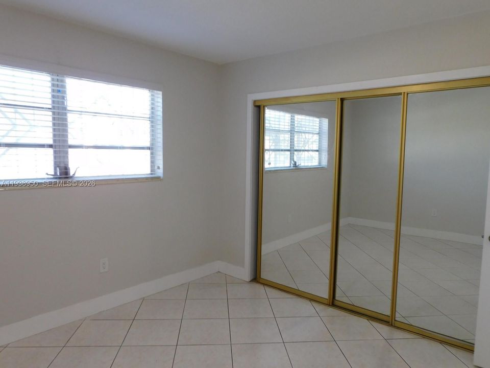 Bedroom #2 with mirrored closet doors.