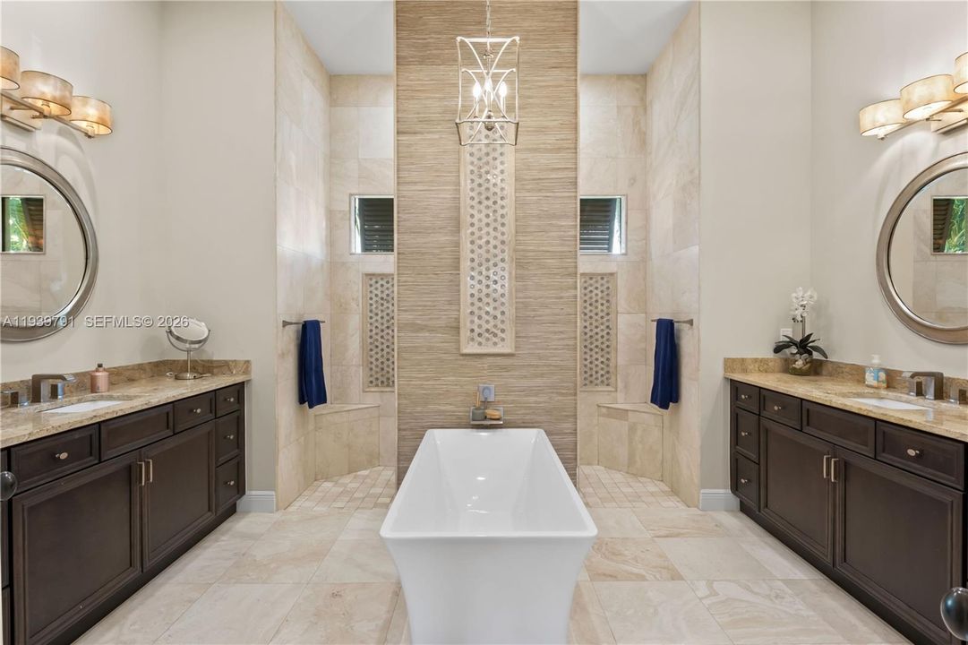 Luxurious master bath with travertine floors, soaking tub, perfect for unwinding.