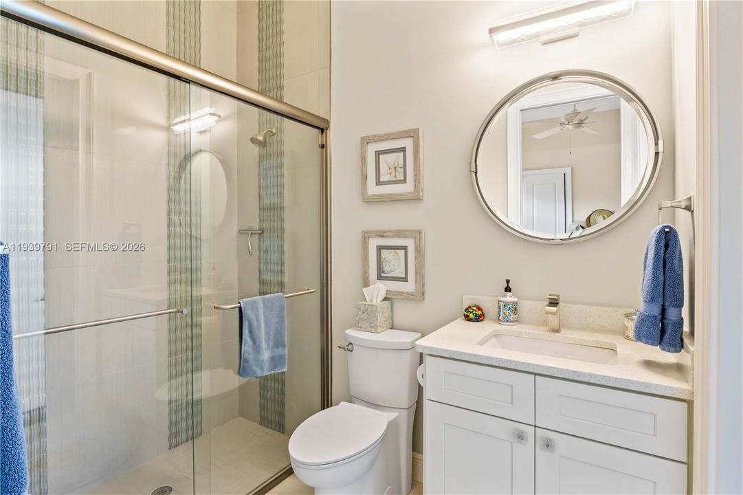 Elegant guest bathroom that serves as a junior master suite with access to the outdoor pool area as well!