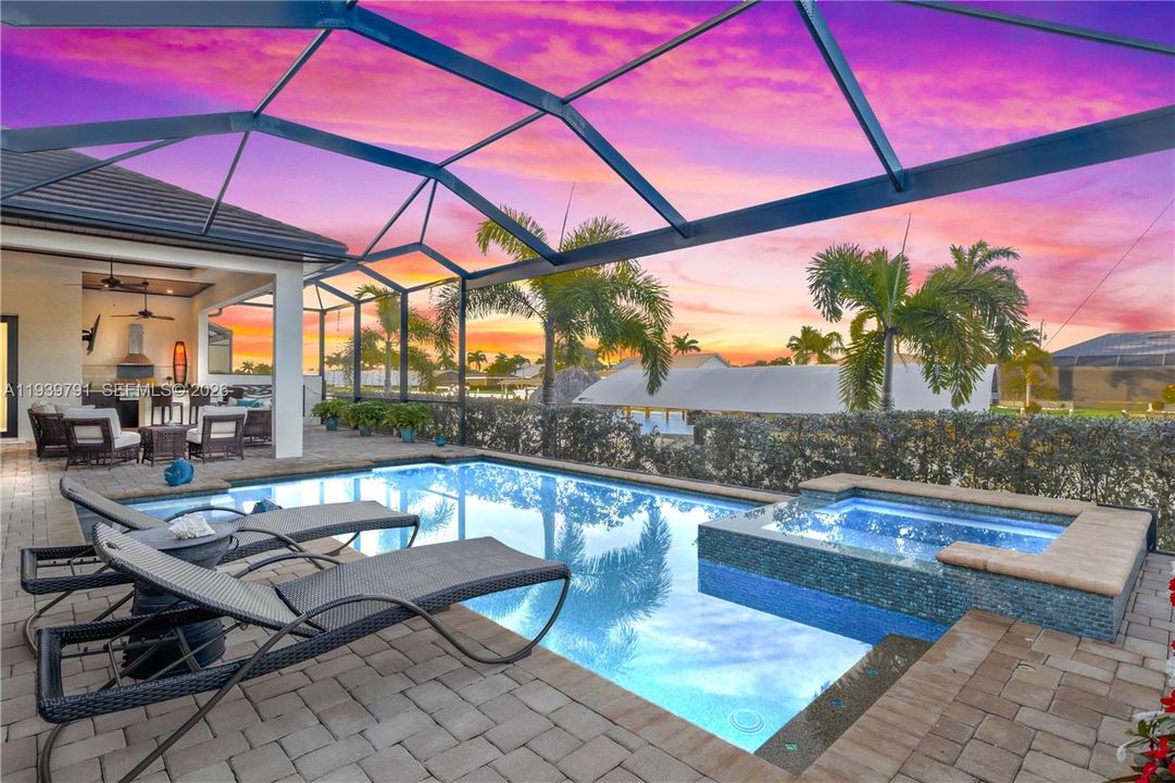 Tranquil poolside retreat with ambient lighting, perfect for evening swims while watching spectacular sunsets paint the sky over the waterway. Sparkling pool and heated spa and multiple outdoor seating areas - not your average home!