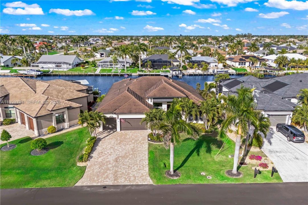 Aerial shot featuring the full estate and waterfront, illustrating both the home’s grandeur and the beauty of its serene, tropical setting.