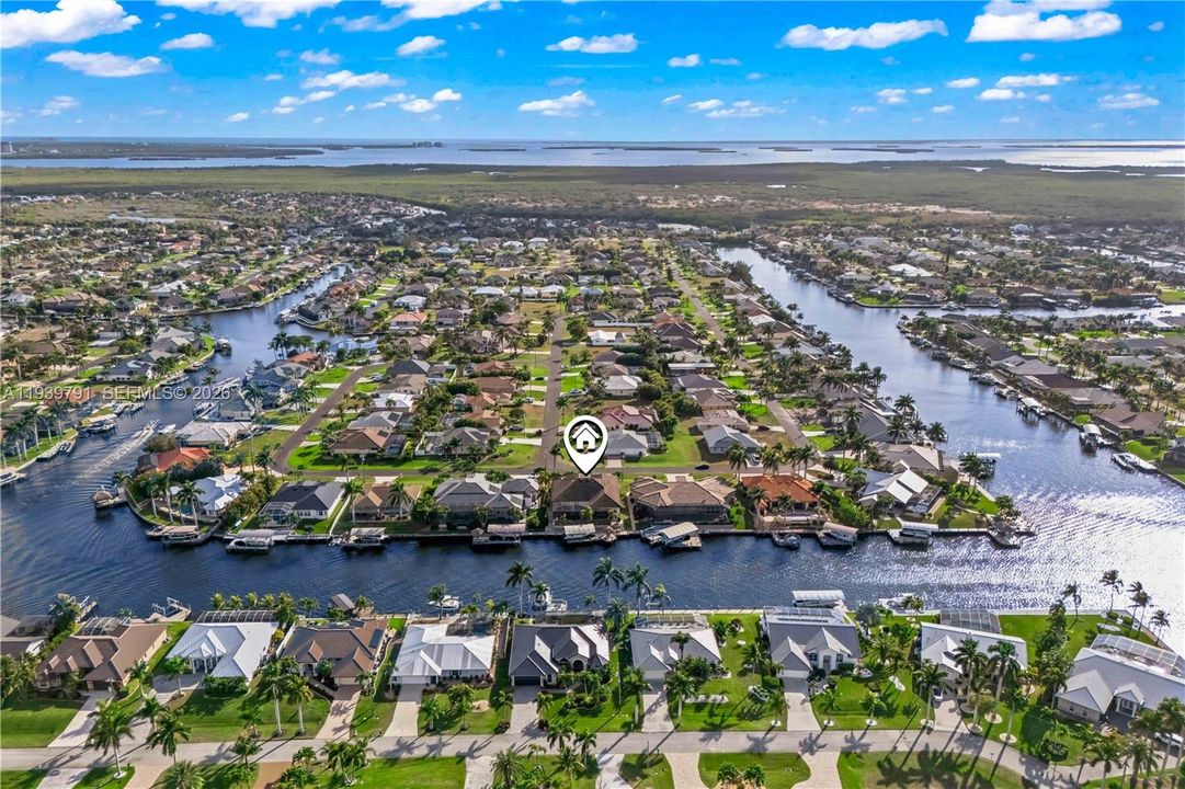 Elevated perspective highlighting the home’s private location and stunning Cape Coral surroundings.
