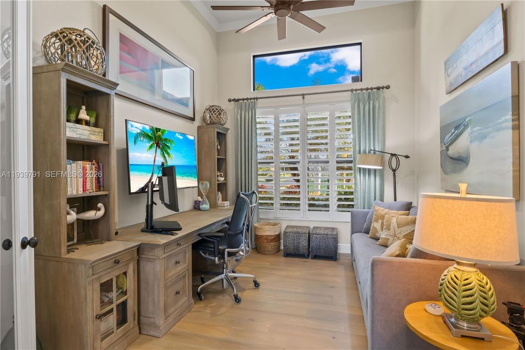 Elegant study featuring custom cabinetry, rich flooring, and a tranquil workspace.