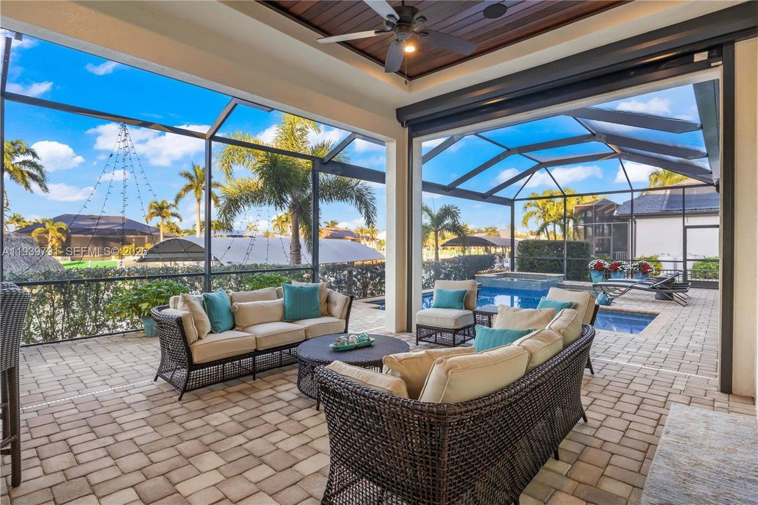 Luxurious outdoor living space with tropical landscaping and unobstructed sunset vistas.