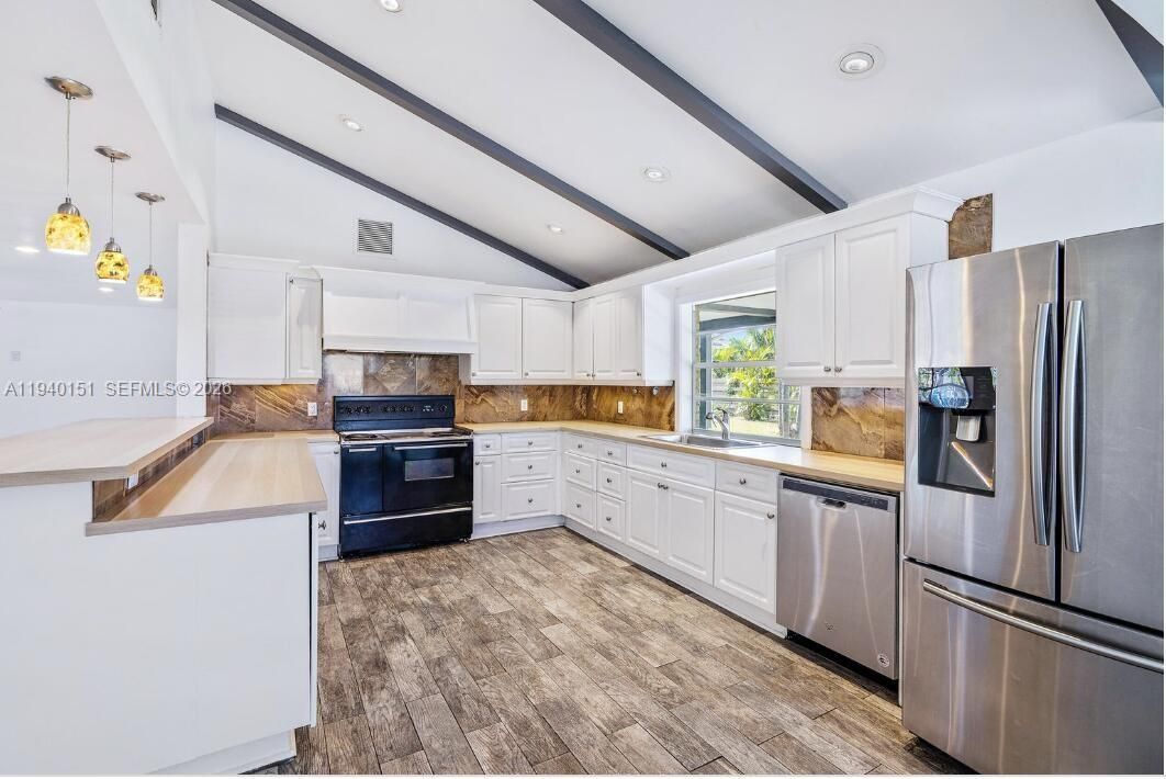 Kitchen with vaulted ceilings