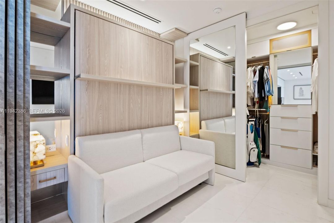 Den with closet slider open; roller door added for a sleeker look.