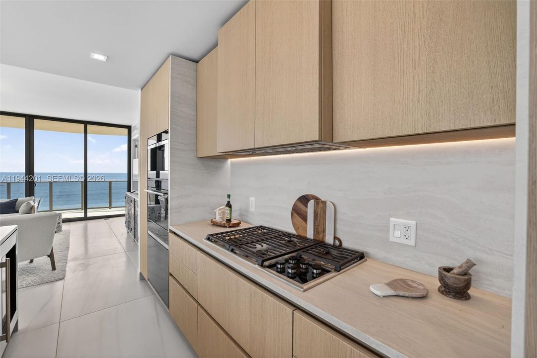 Chef-ready galley kitchen with Sub-Zero and Wolf appliances w/ wine cooler, plus integrated espresso/cappuccino system. Italian cabinetry and stone counters. Gas Cooktop