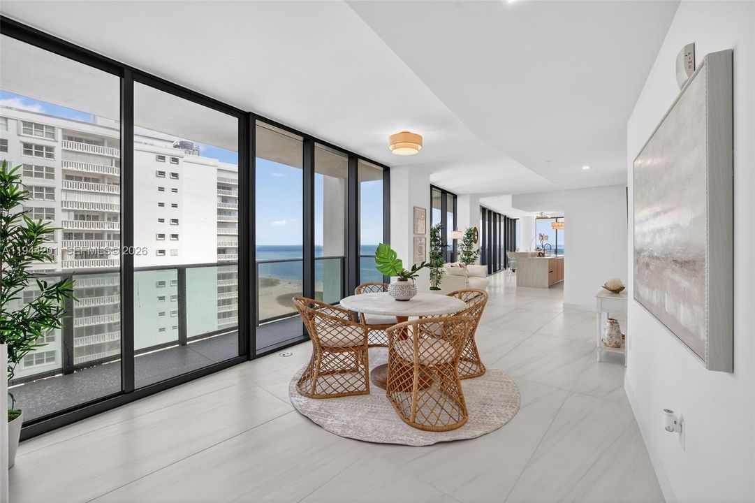 Open dining area with floor to ceiling glass, adjacent to chef’s kitchen and terrace for seamless indoor outdoor entertaining. This area is also a possible den / 4th bedroom as per the builders plans. Unit is a 4 bedroom per tax roll