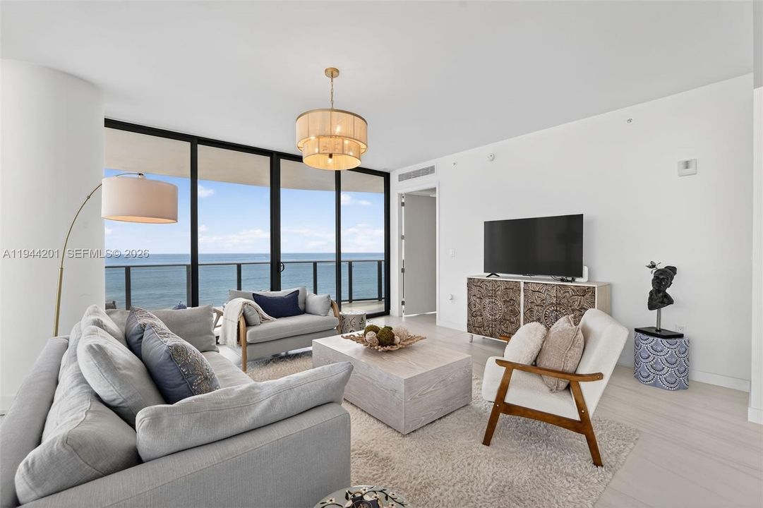 Light filled open living area with floor to ceiling glass and seamless indoor outdoor flow to expansive terrace.