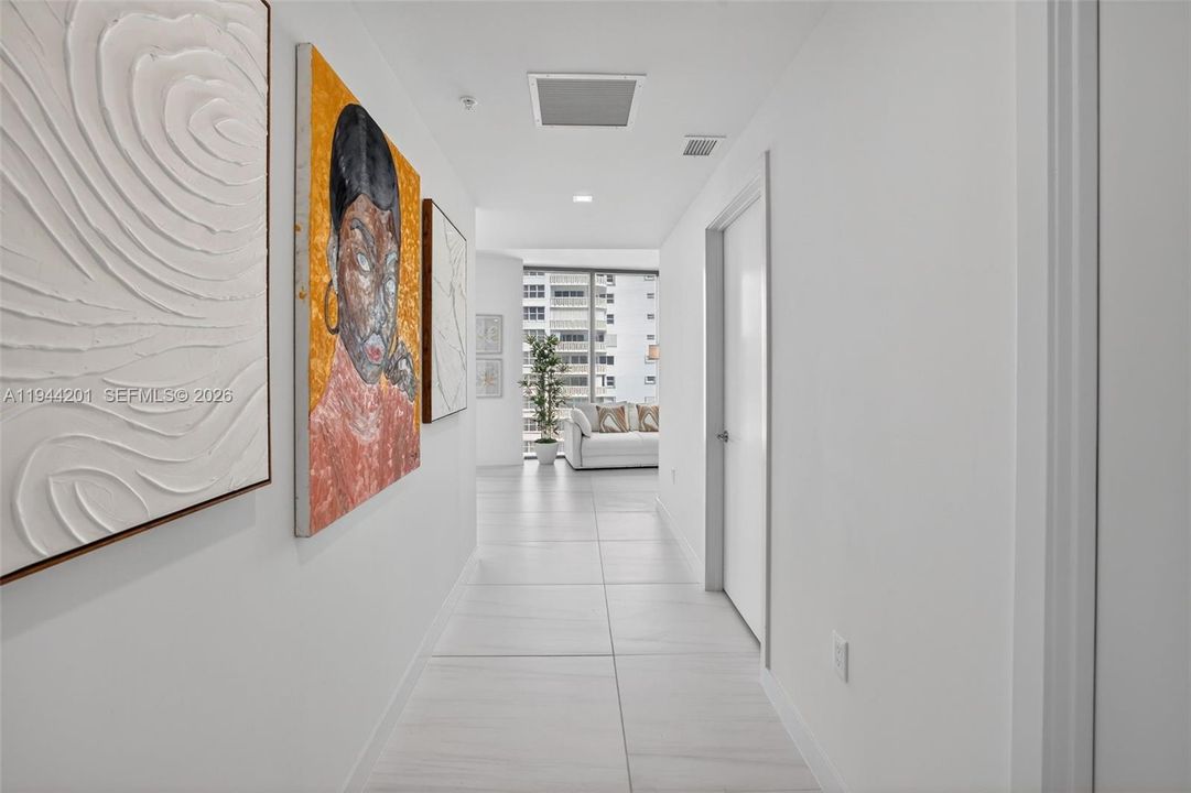 Foyer Hallway from entrance / elevator to unit. Doors on right are powder room and utility room / laundry