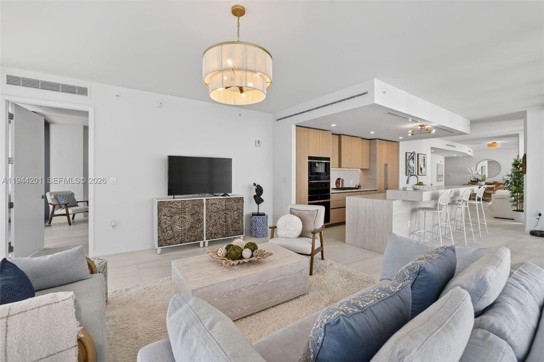 Light filled open living area with floor to ceiling glass and seamless indoor outdoor flow to expansive terrace.