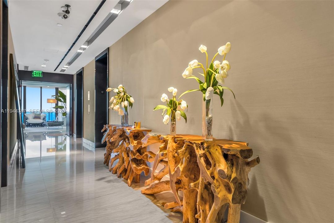 Step out of your private elevator and step into your MASSIVE private  foyer! To the left you have the entrance to the living room and dining room facing the ocean and to the right are all of the bedrooms.