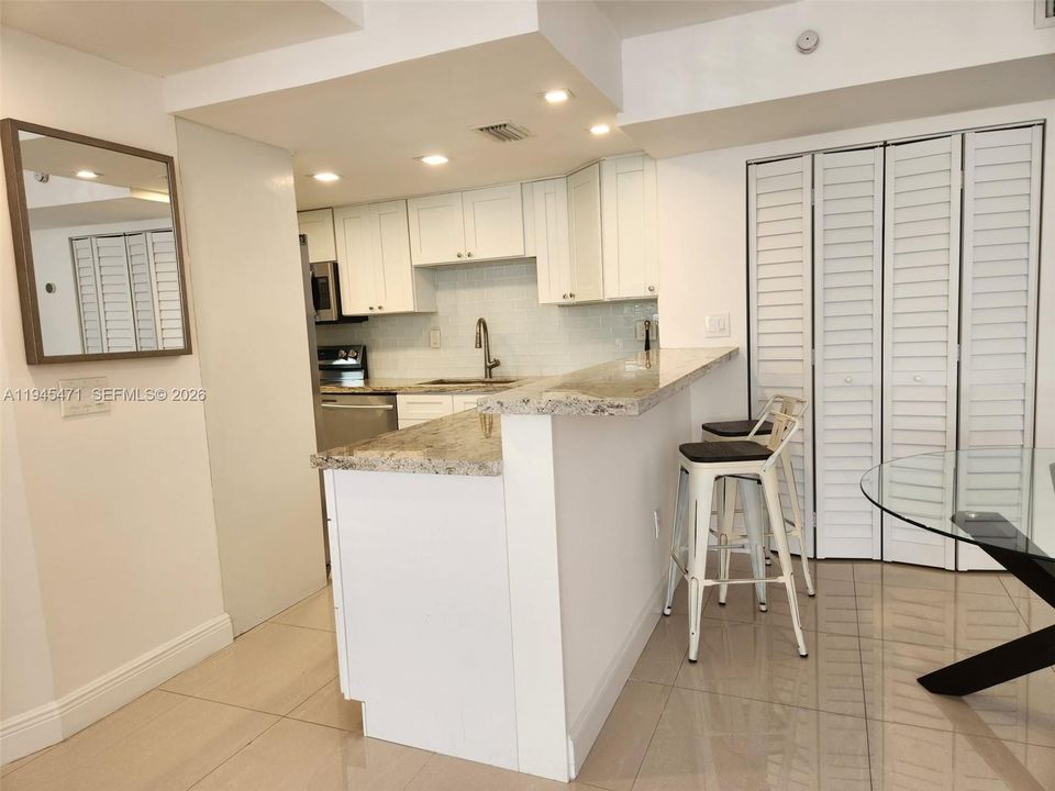 Additional Kitchen view shows bar area allows for additional eating space.