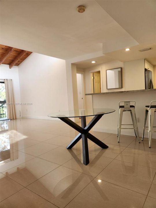 This view shows relationship between living space, kitchen, second bedroom & bathroom.