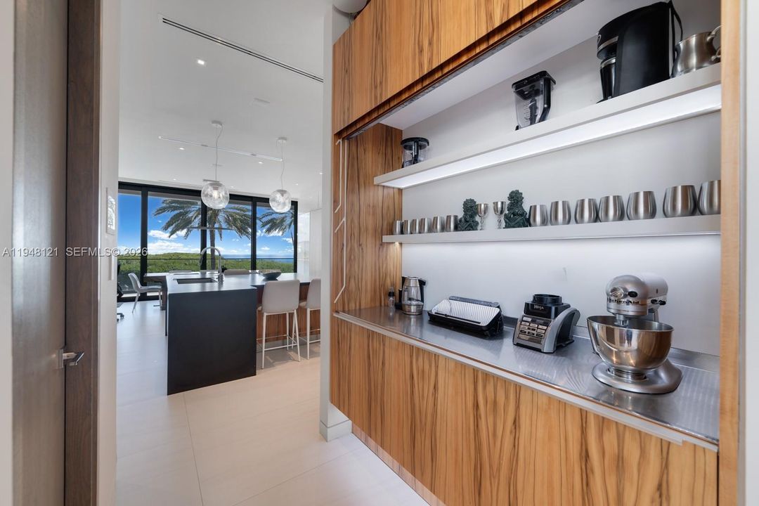 Butler's pantry straddling the kitchen and the formal dining room is perfect for entertaining and busy families.
