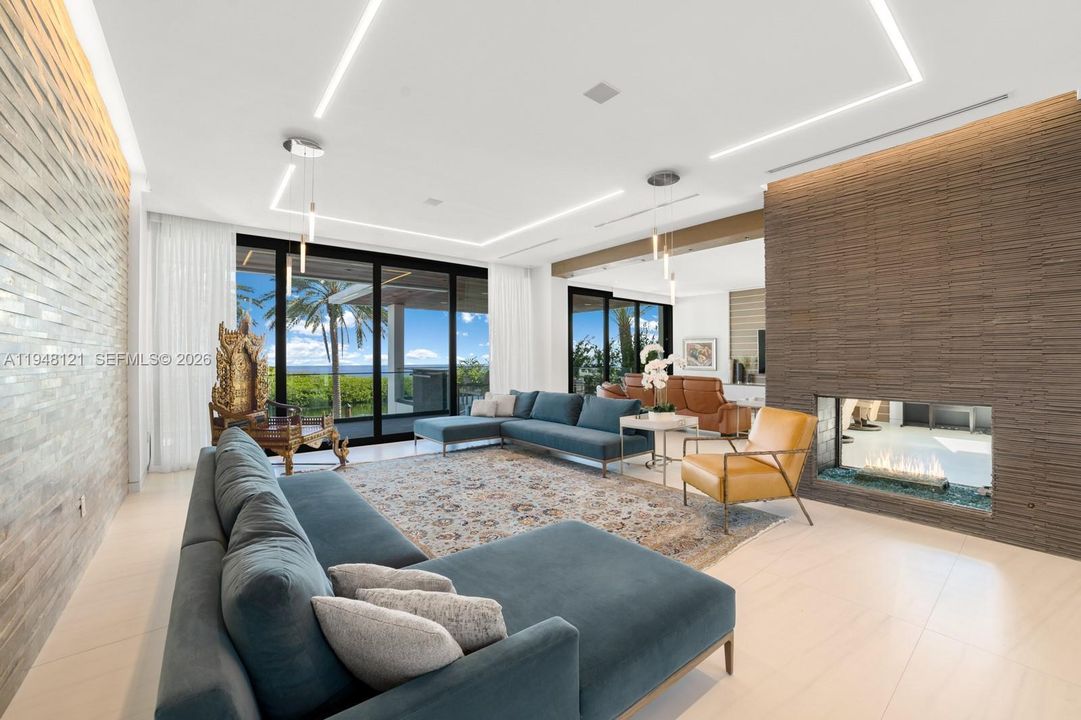 Living room with floor-to-ceiling sliders and a featured wall with a built-in gas fireplace.