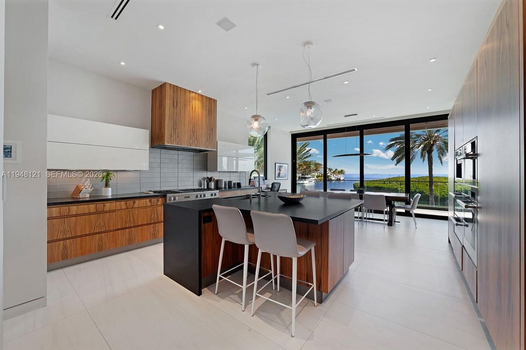 Gourmet Kitchen with high-end appliances, sleek design by Becker, and spectacular views.