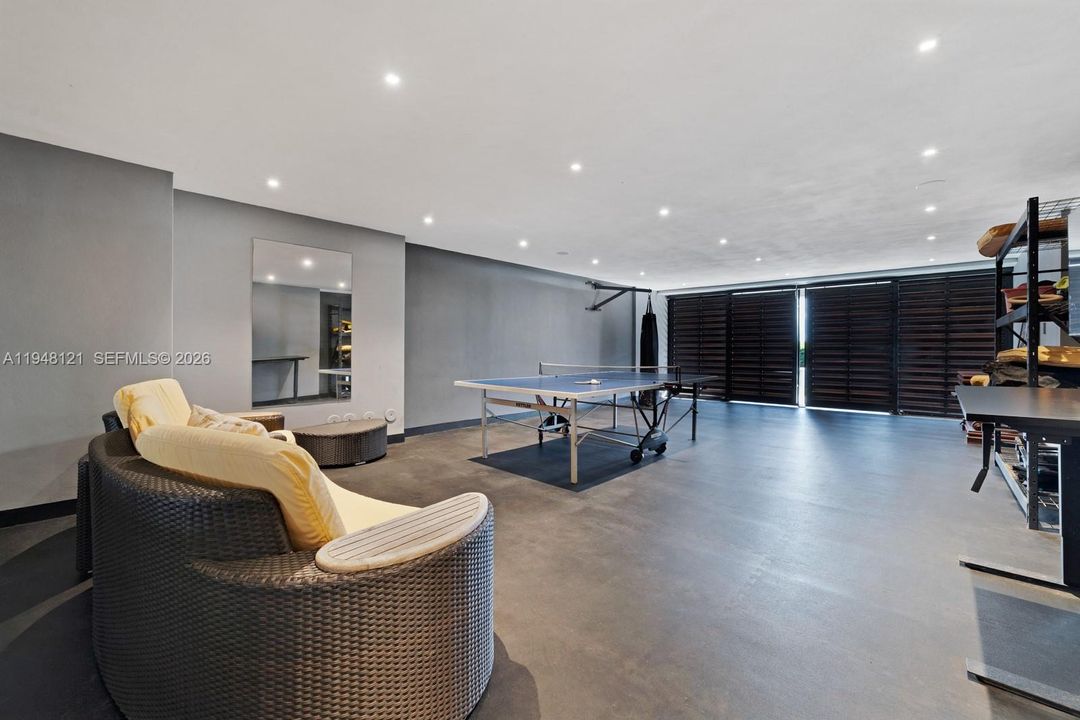 Indoor covered game area with barndoors to open to the back yard.