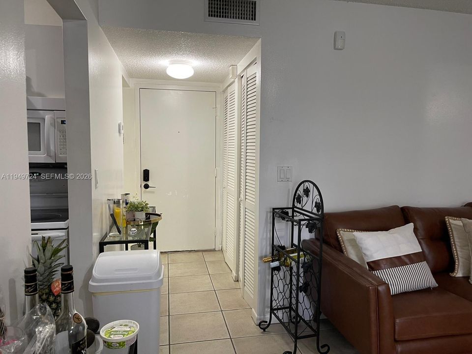 Foyer leading to half bath, kitchen & LR