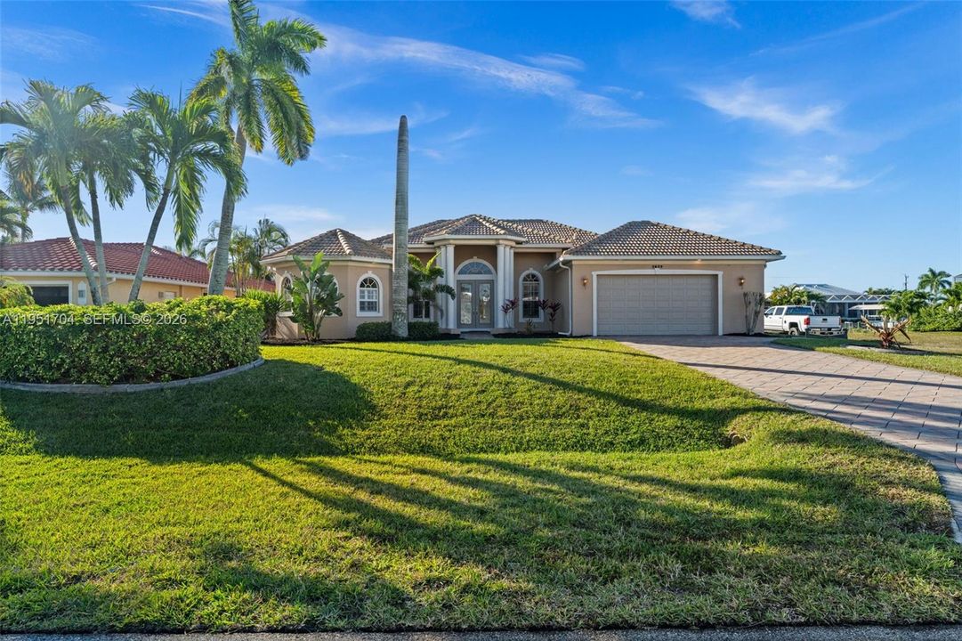 Beautiful curb appeal with tropical landscaping