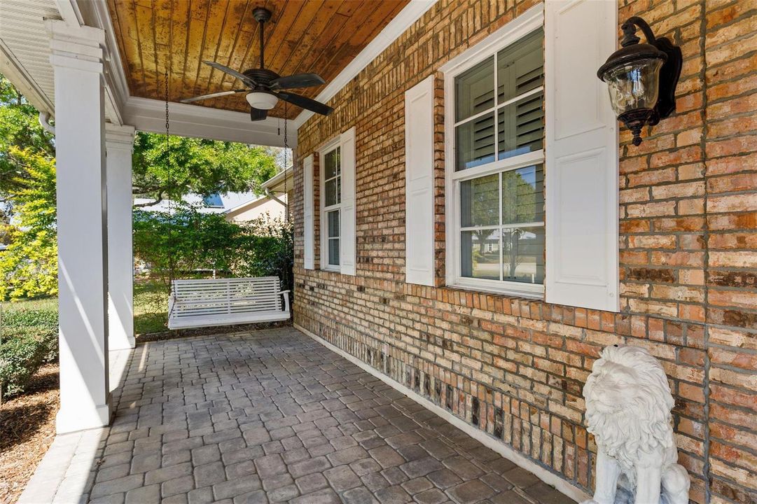 Front porch with two swings swings.