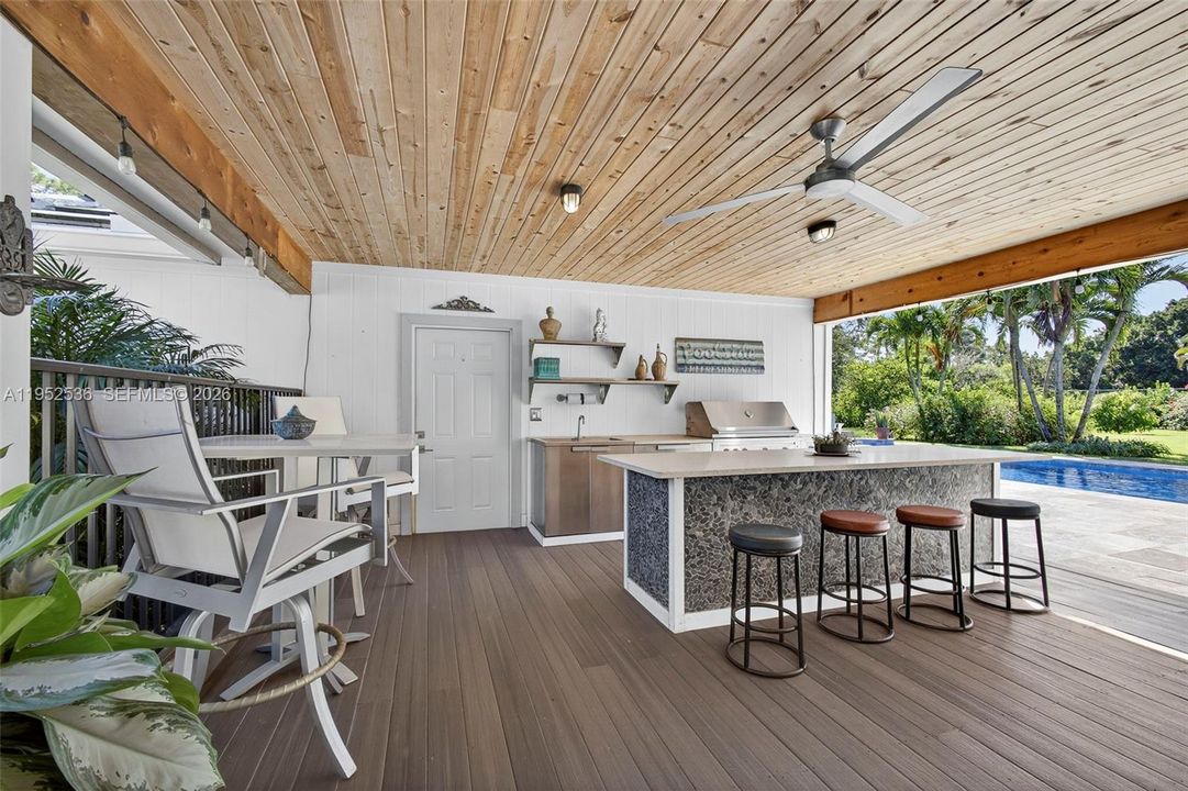 Outdoor built-in grill and bar area with island
