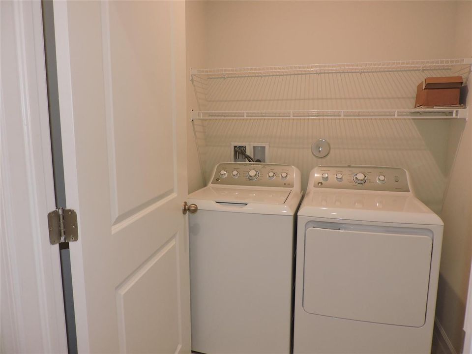 LAUNDRY ROOM WITH STORAGE SHELVES