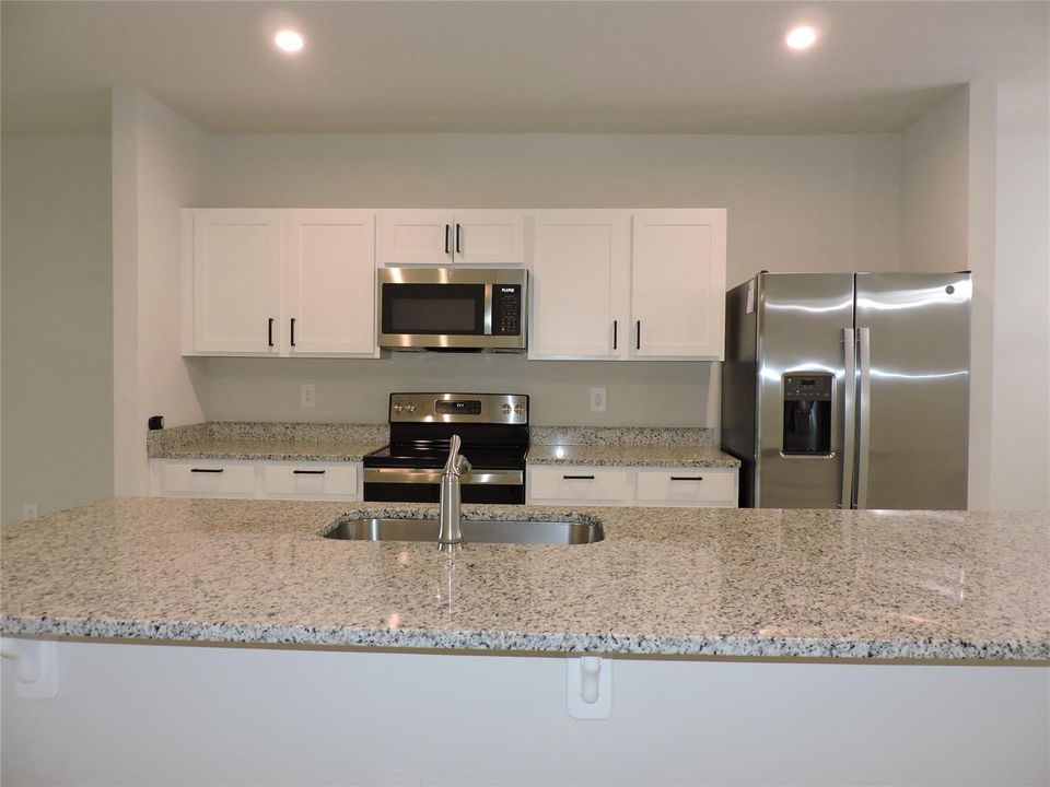 KITCHEN ISLAND WITH GRANITE COUNTER TOPS