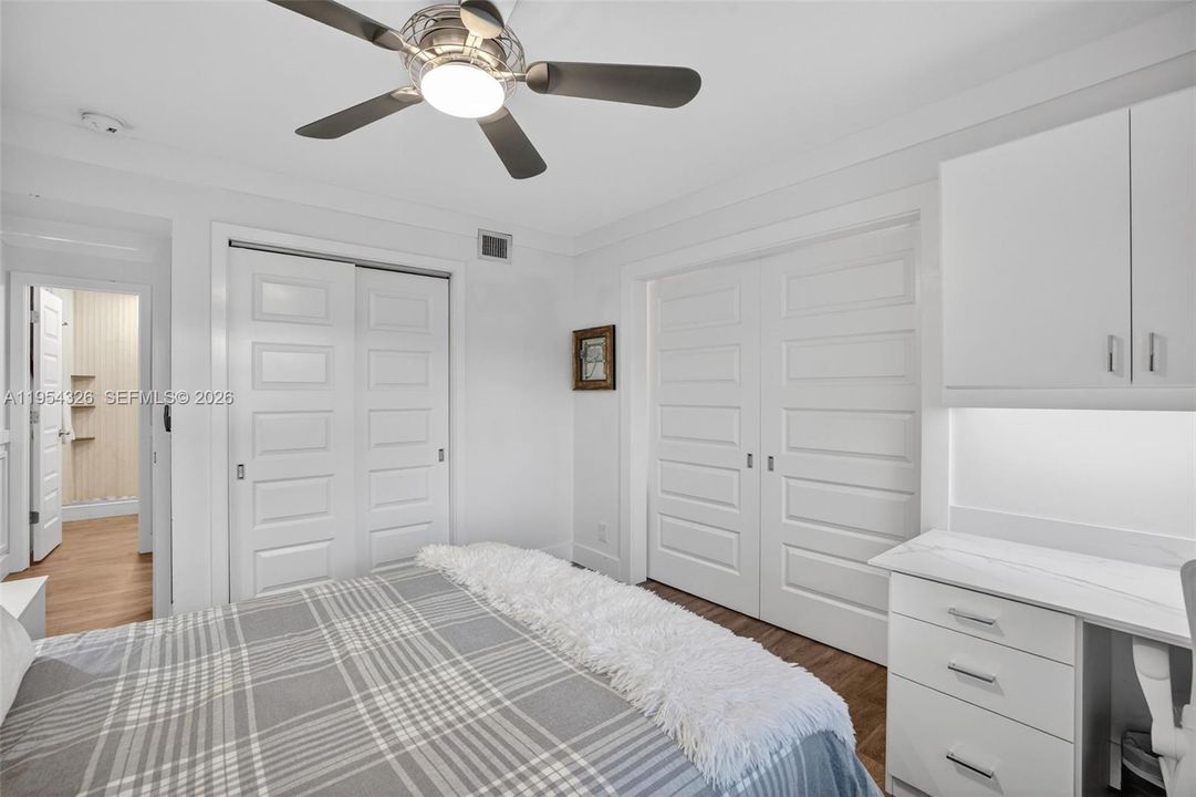 3rd bedroom w/ murphy bed wall system and built in desk w/ quartz counter and window shutters