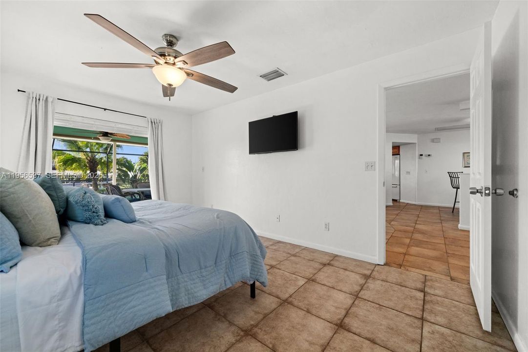 Primary Bedroom has pocketing sliders to the pool