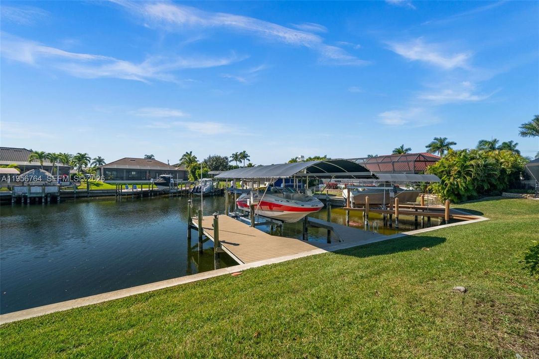 Private dock with boat lift and canopy