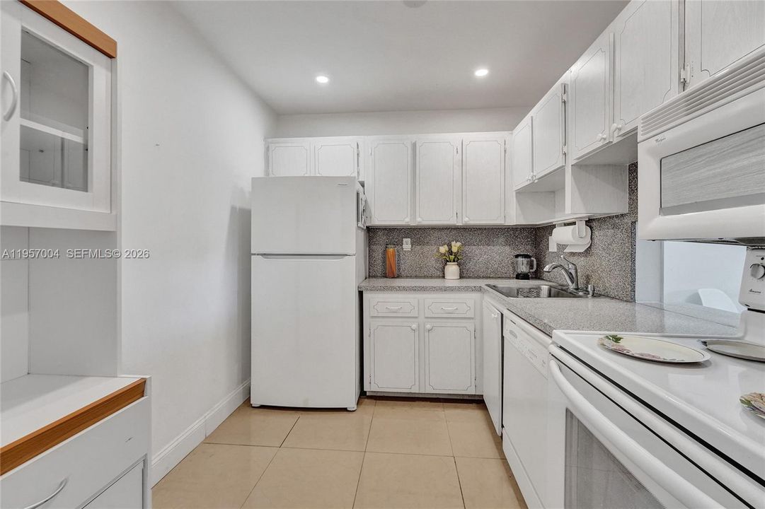 Spacious kitchen with sleek tile floors, offering a clean and modern aesthetic
