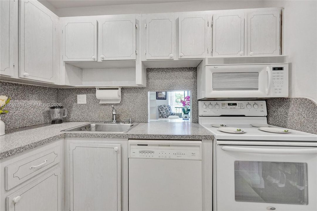 Spacious kitchen with sleek tile floors, offering a clean and modern aesthetic
