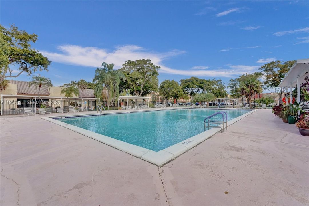 The condo features a relaxing pool area, perfect for unwinding and enjoying the sun in a tranquil setting.