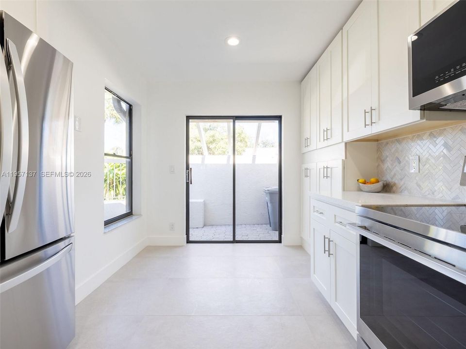 Spacious kitchen with additional cabinet space/pantry area, and cute space for a breakfast nook.
