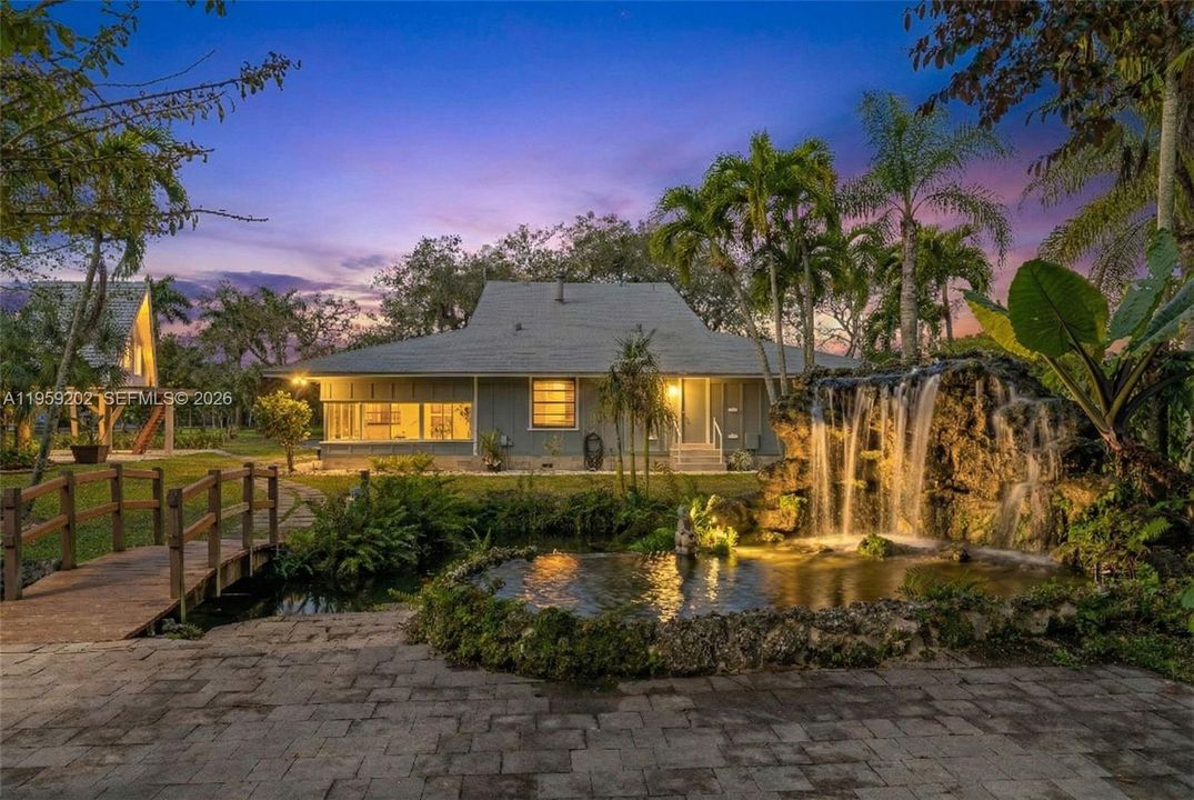 NIGHTTIME VIEW, SIDE OF HOUSE VIEW OF LAGOON W/ TREEHOUSE IN THE BACKGROUND.