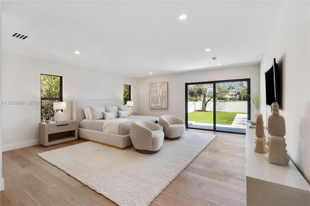 Primary bedroom on ground floor, sliding door into the backyard.