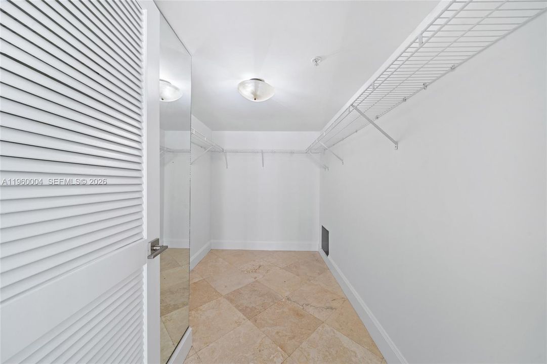 Primary bedroom features a walk-in closet