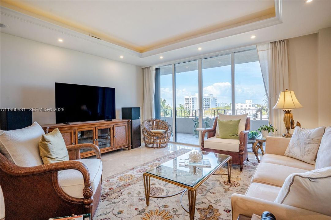 The Living room features floor-to-ceiling glass doors that allow natural light to flood the space.