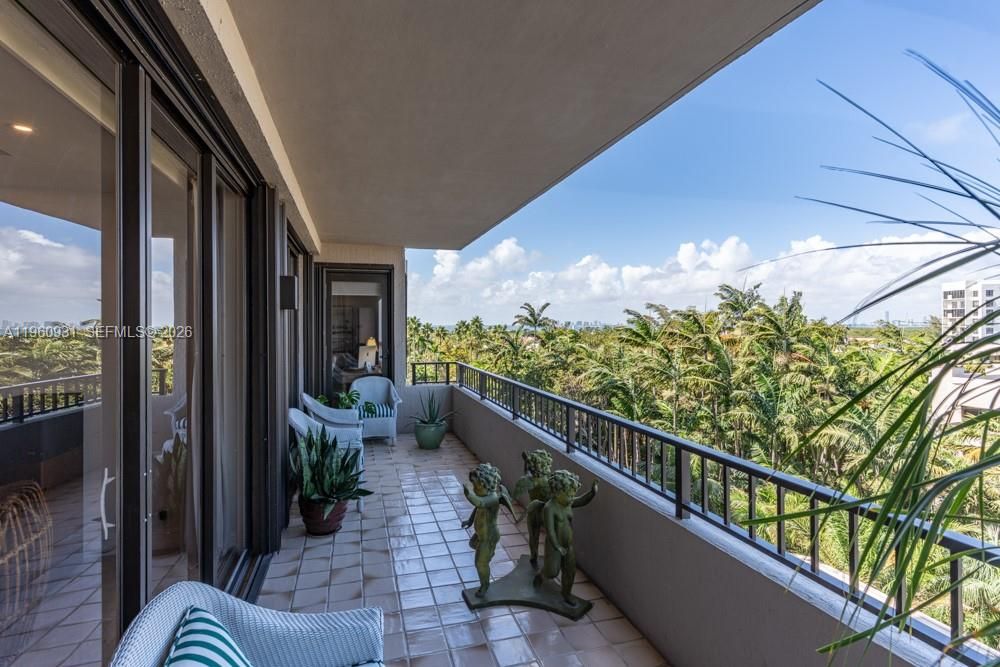 Marvel at the breathtaking panoramic vistas of palm trees, with Biscayne Bay, the city skyline, and the ocean providing a stunning backdrop.