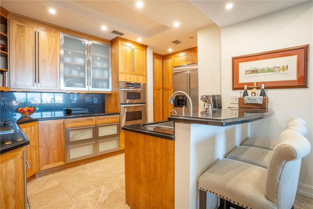 The kitchen featured a counter bar.