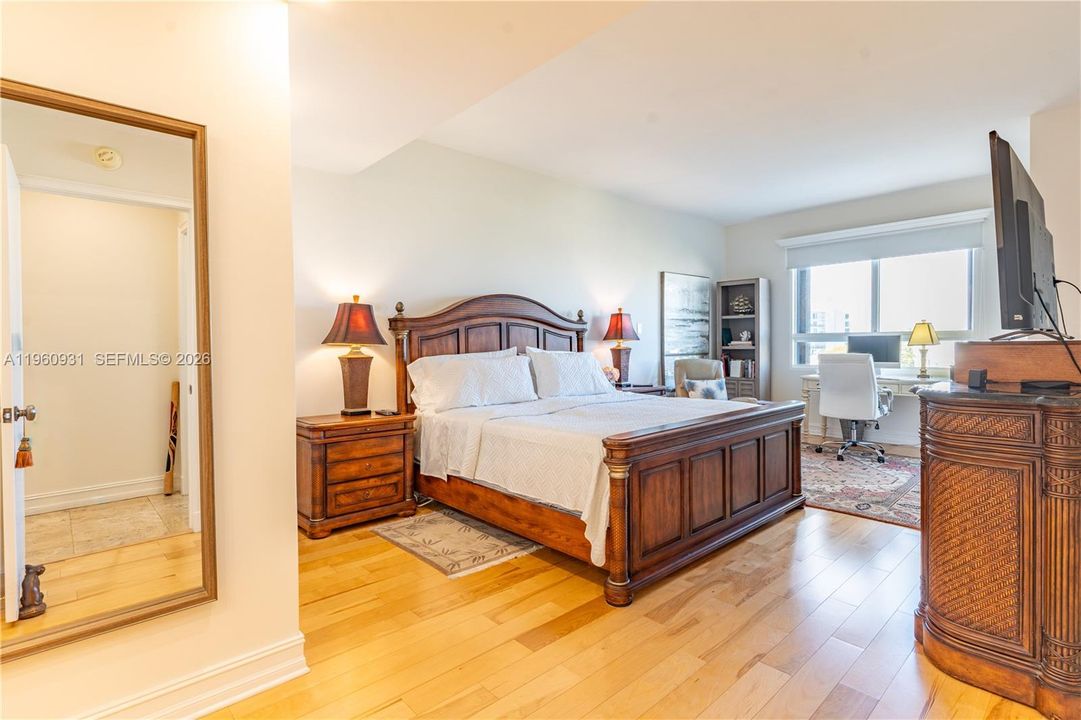 The primary bedroom is spacious and features a closet and seating area.