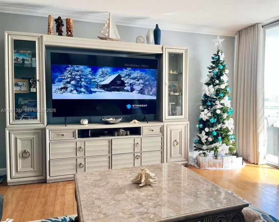 Built-in wall cabinetry featuring glass-front display towers, integrated shelving, and cabinet storage with circular pulls